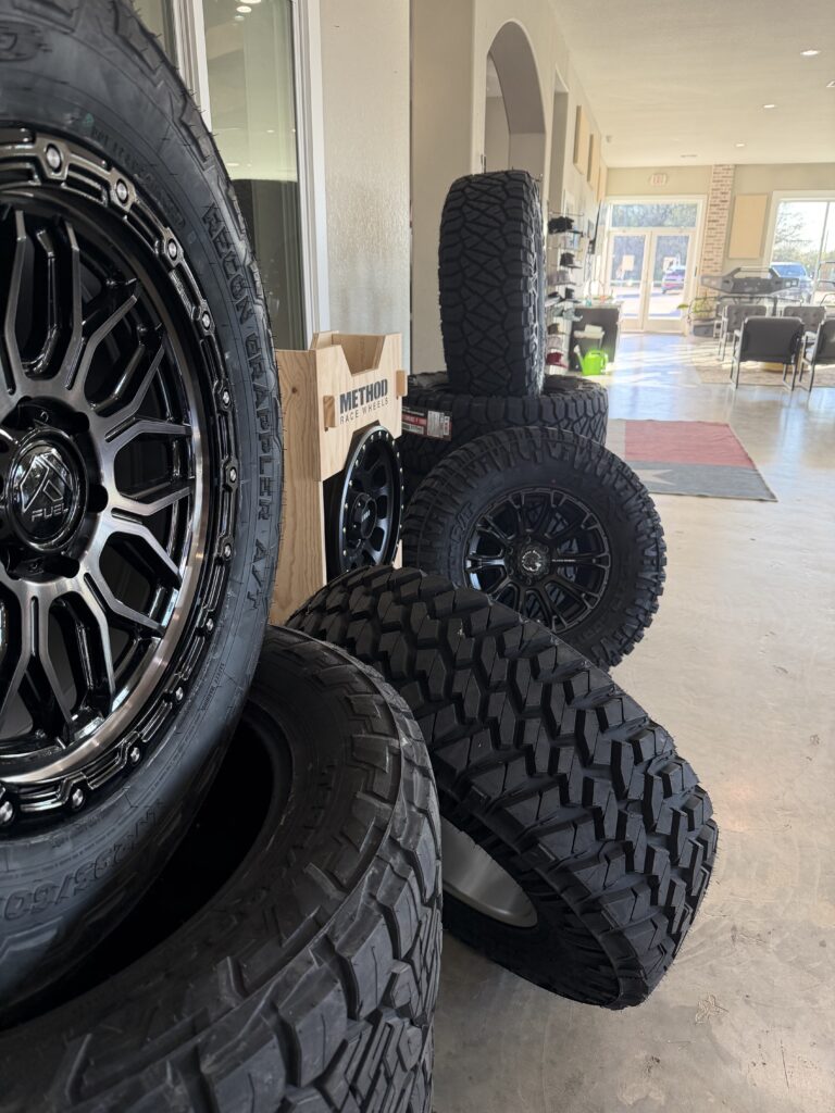 Left side shot of Method Race Wheels display with surrounding tires and wheels.